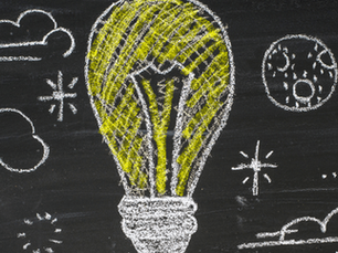 Light bulb and clouds drawn on a chalkboard, representing startup marketing ideas