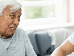 Older man discussing Medicare coverage questions with a doctor