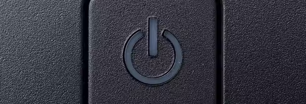 A grey power button for a computer, the most basic aspect of computer literacy