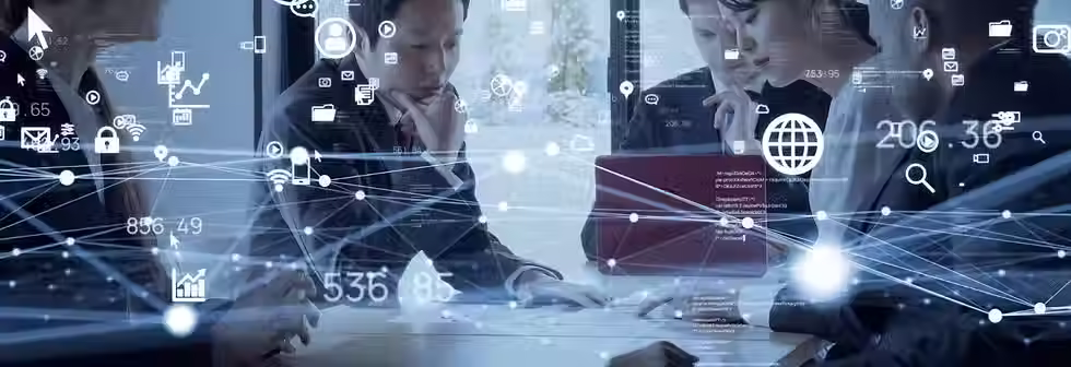 Different businesspeople speaking at a table, overlaid with different virtual business icons