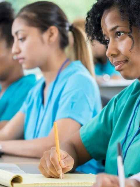 A classroom of aspiring nursing students prepare for their Nurse Practitioner transition into the workforce. 