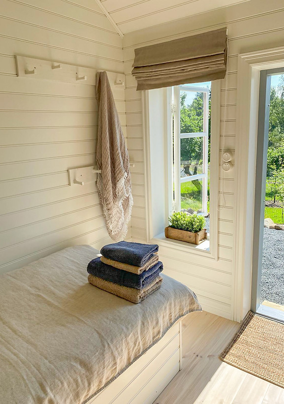 Luxury Finnish villa bedroom with pristine linens and towels perfectly arranged, ready for guests, offering high-end material