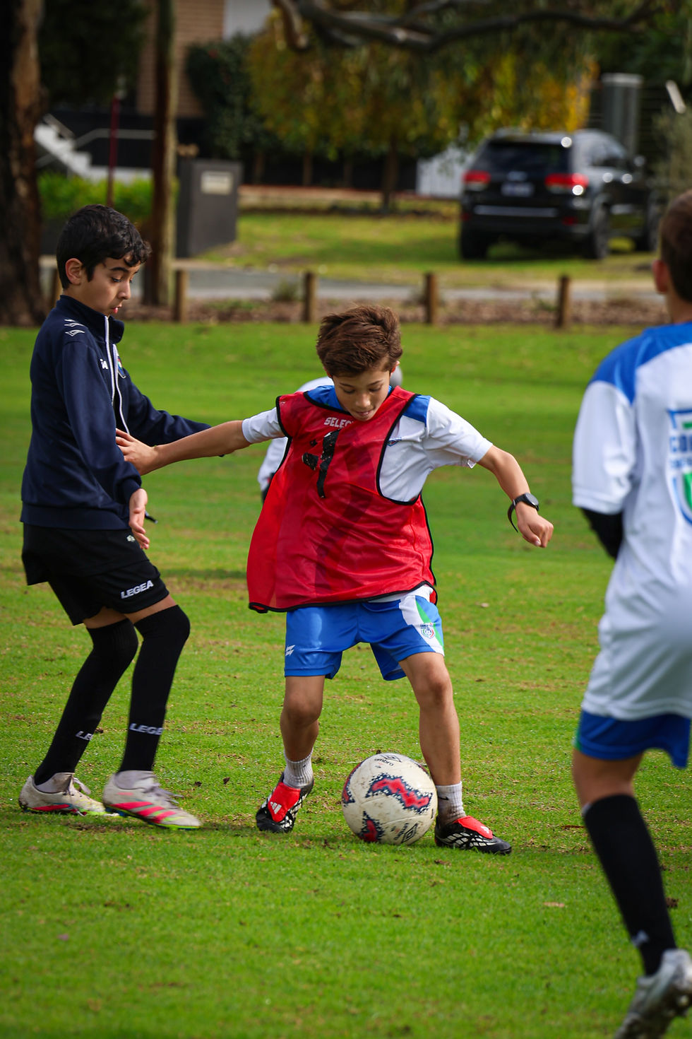 Young footballers engage in a practice session focused on enhancing decision-making skills under pressure, showcasing strategic plays on the field.