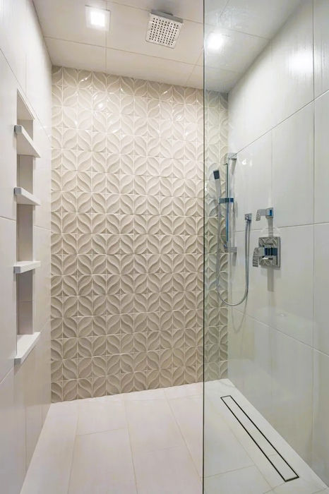Modern bathroom remodel featuring new sink, cabinetry, tiled shower area, and sliding door.