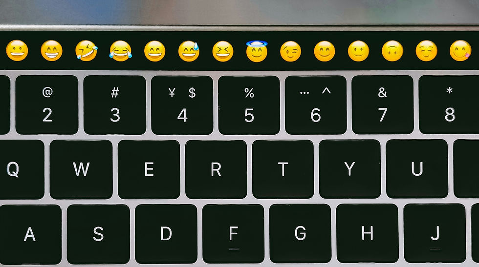 a laptop keyboard with emoji menu shown
