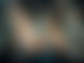 Overhead view of a business meeting with people in suits seated around a long wooden conference table, notebooks and pens in front of them, water glasses on the table, with bright light reflections and a subtle digital network overlay.