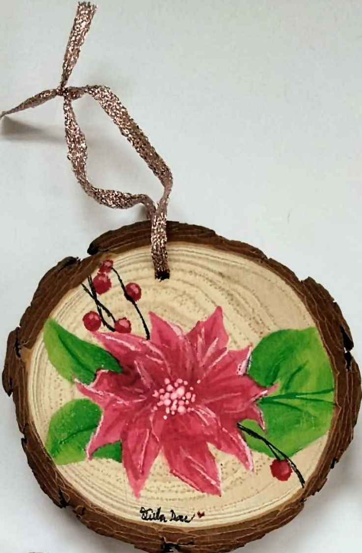 'Pointsettia' ornament art on a wooden base, hung with ribbon
