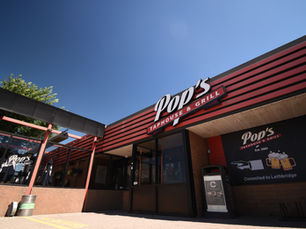 Front entry and patio of Pop's Pub North Lethbridge on a sunny day