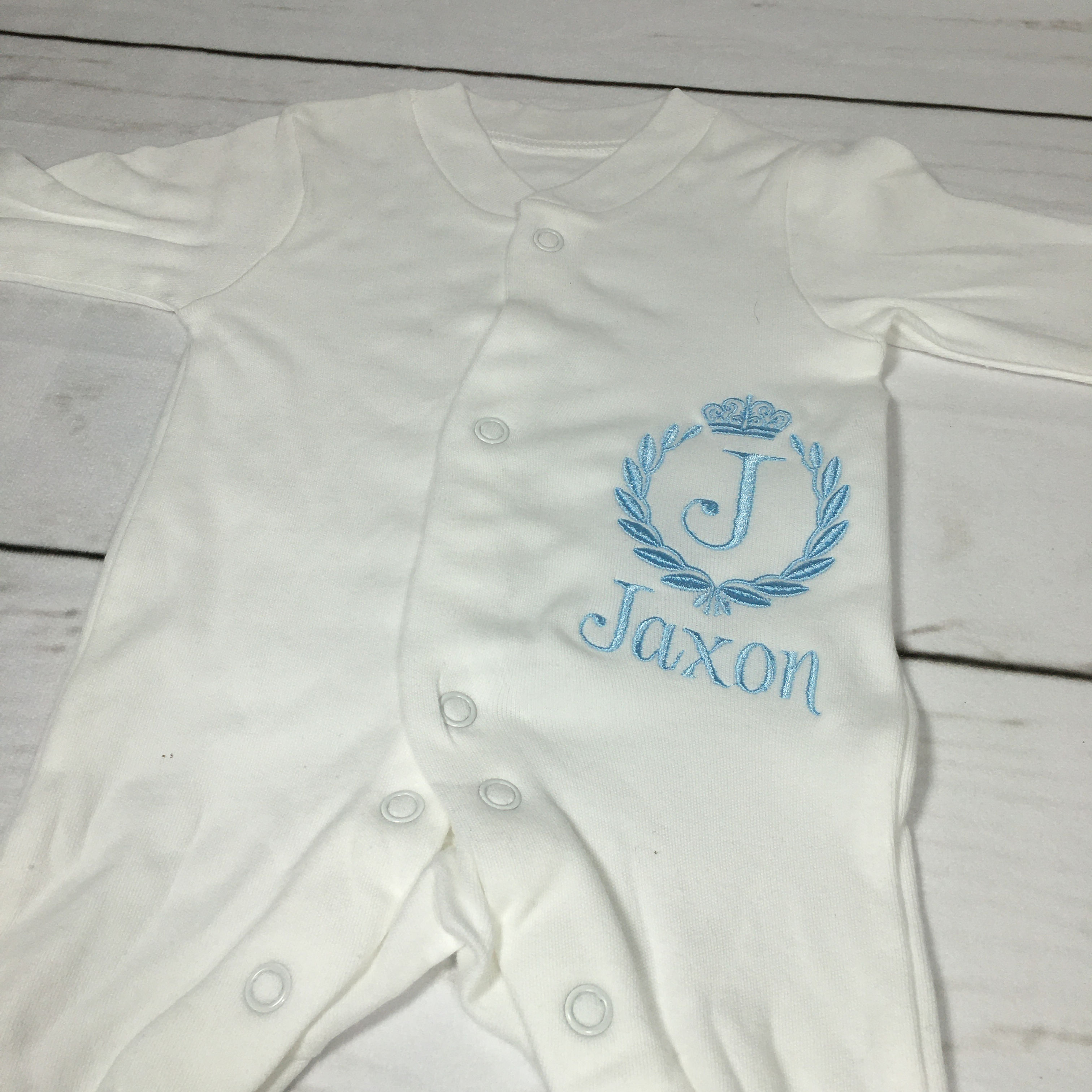 Crown crest initial sleepsuit.