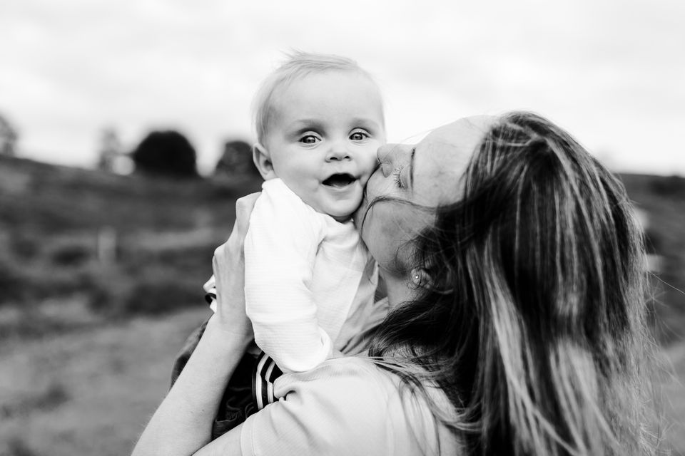 a mom lovingly hugging her baby during their photoshoot with Snap Me Pretty