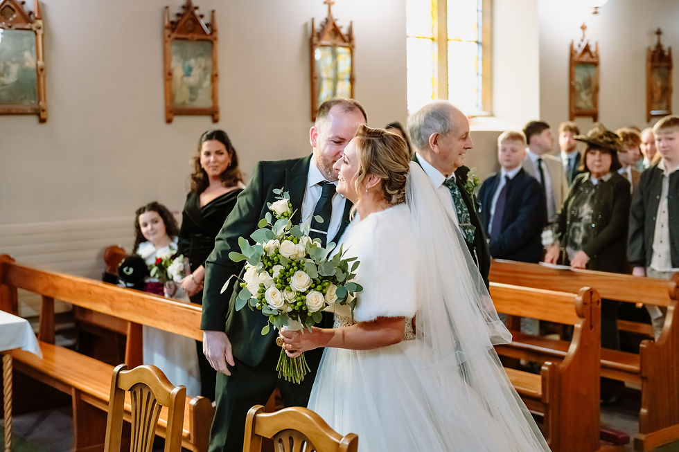 The image shows a bride and groom standing in the gardens of the Leighinmohr house hotel in Ballymena for a nice bridal portrait. 
