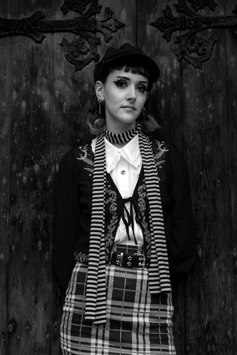 Person in vintage-style clothing, black and white photo.