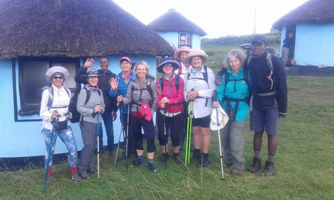 A group of hikers outside the colourful African huts which are so characteristic of the Wild Coast.