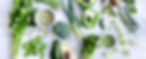 Healthy spread of green vegetables on rustic white background from overhead, broccoli, cel