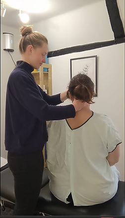 Chiropractor examining a patient's neck, Chiropractic treatment in a clinic setting.