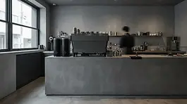 Modern minimalist coffee bar with industrial concrete textures and matte black equipment. HEX ZERO's curated aesthetic of #000000 black wear and functional urban design.
