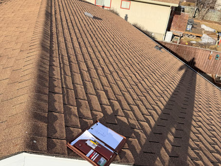 Aging asphalt shingler roof in Red Deer showing wear and granule loss, indicating need for roof replacement by a local roofing contractor