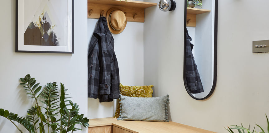 Entrance hall with patterned tile floor and bespoke storage