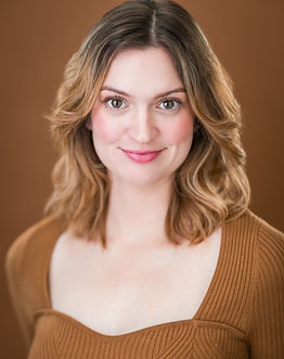 Angela Price. She is a fair-skinned adult woman with light brown hair. She is wearing a brown shirt with a heart neckline.