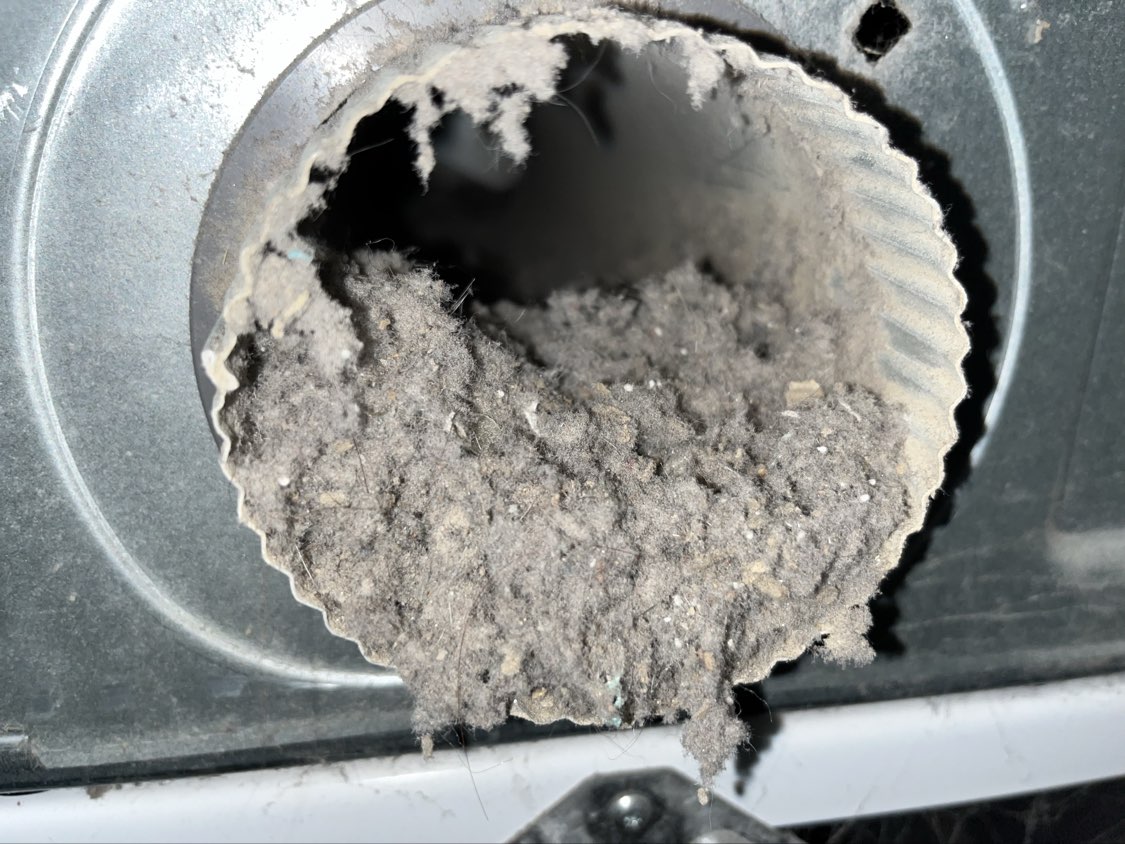 Clogged dryer vent exterior cap packed with lint — Marysville Ohio home