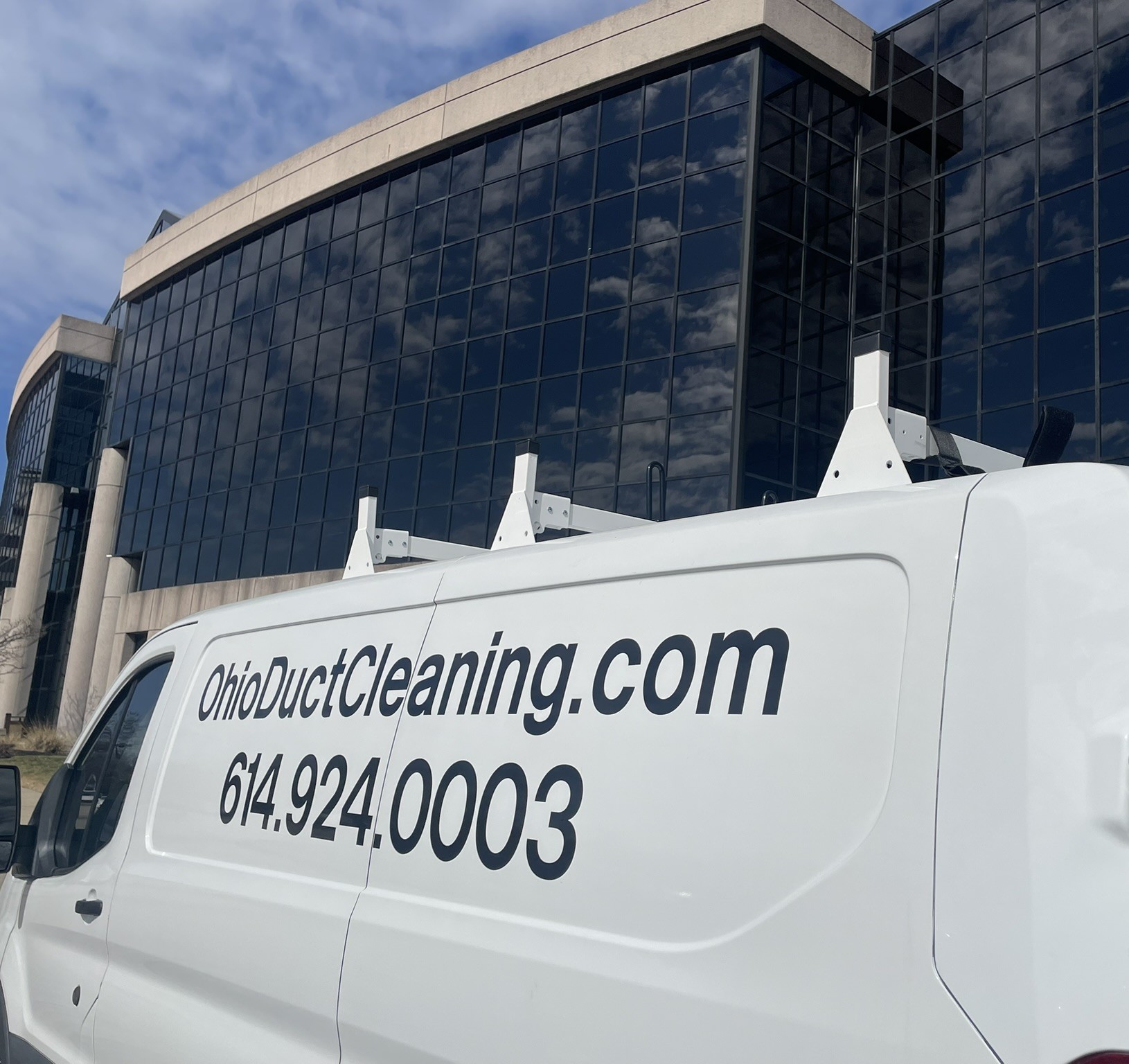 Clean Air Pros van at glass office building commercial duct cleaning Columbus Ohio