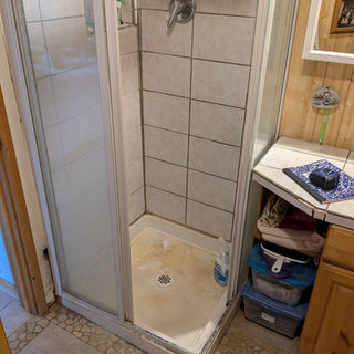 A before picture of a bathroom remodel showing a poor tile installation.