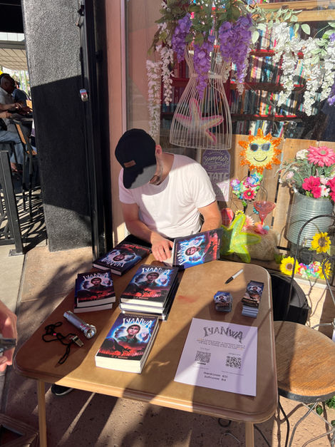 CJ Biggin signing his book, IYANWA