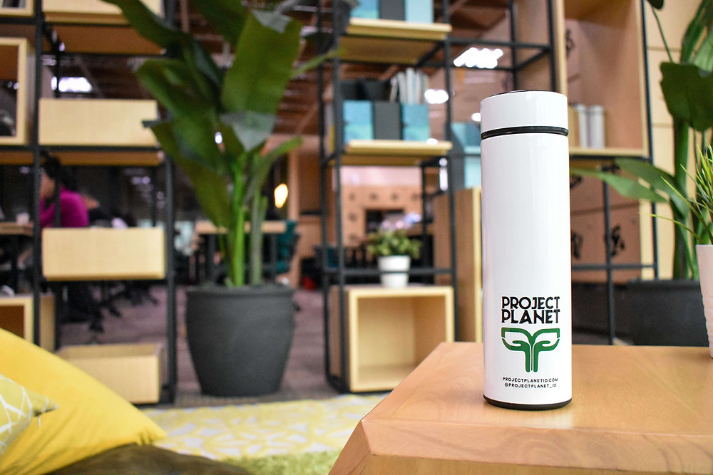 A white Project Planet Indonesia tumbler on a table