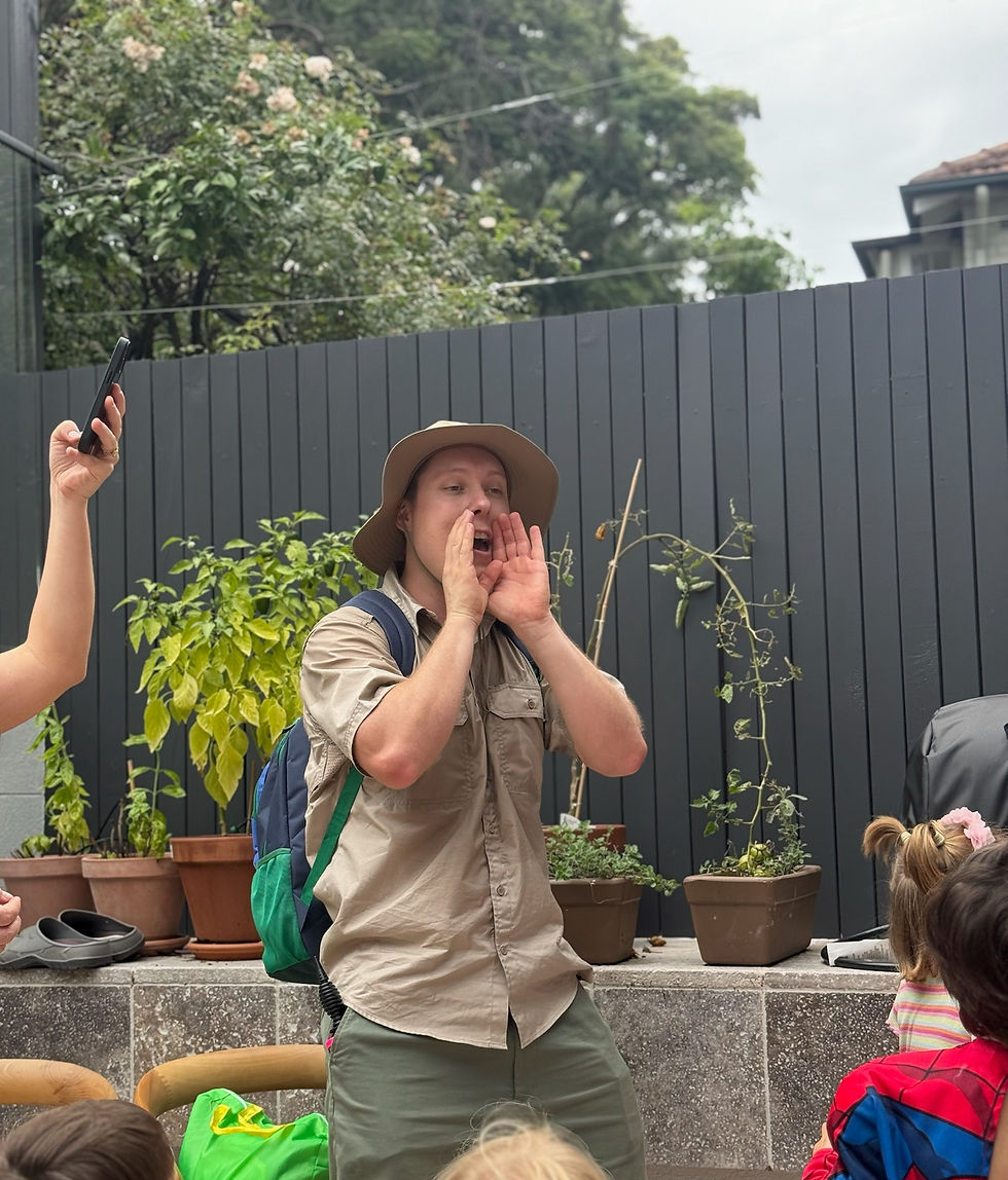 Kids party entertainer leading an outdoor explorer-themed activity with children at a birthday party