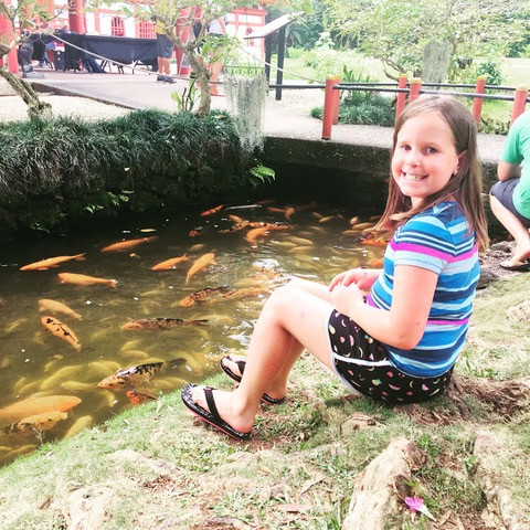 Addison sitting by a pond