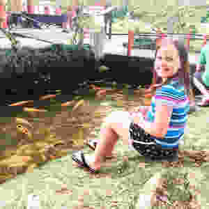 Addison sitting by a pond