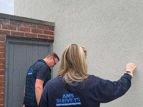 Surveyor investigating suspected subsidence cracking in a house