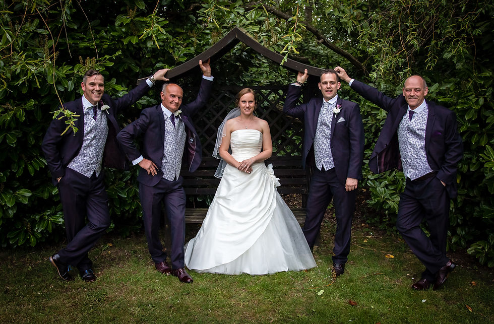 Bride stood in the middle of groomsmen