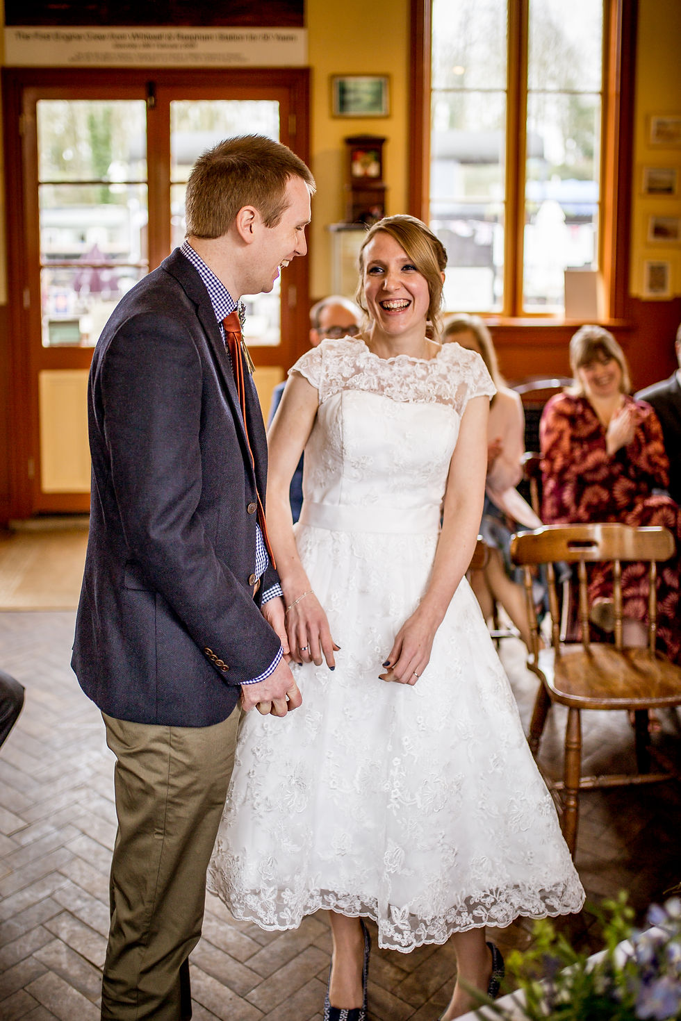 Bride and Groom laughing at Whitwell and Reepham Station