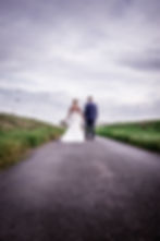 Autumn Wedding - Bride and Groom Wedding Photograph of them walking down a country lane to their wedding venue at Elm Farm Country House, Norwich