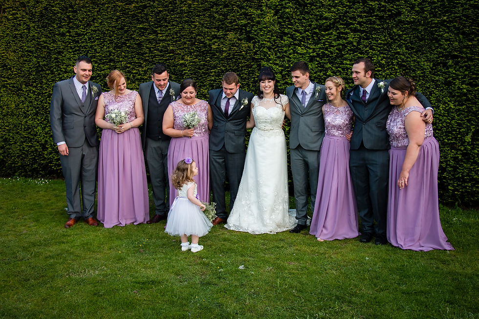 Wedding party distracted from formal photo's from Flower Girl