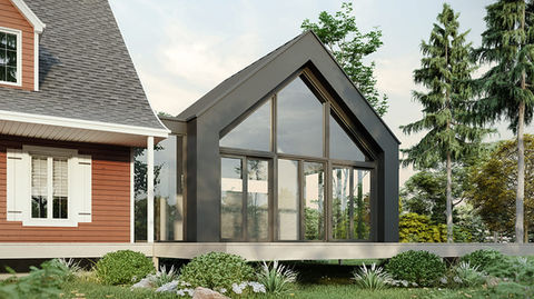 Extension contemporaine avec grande façade vitrée ajoutée à une maison traditionnelle.