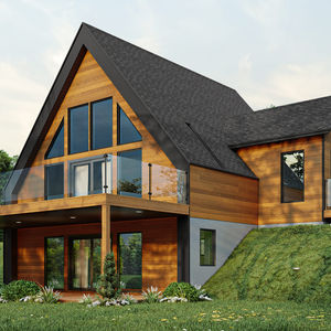 Perspective arrière d’un chalet contemporain avec terrasse vitrée et terrain en pente