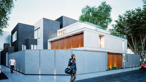 Vista en esquina de casa moderna con lamas de madera y cerco iluminado.