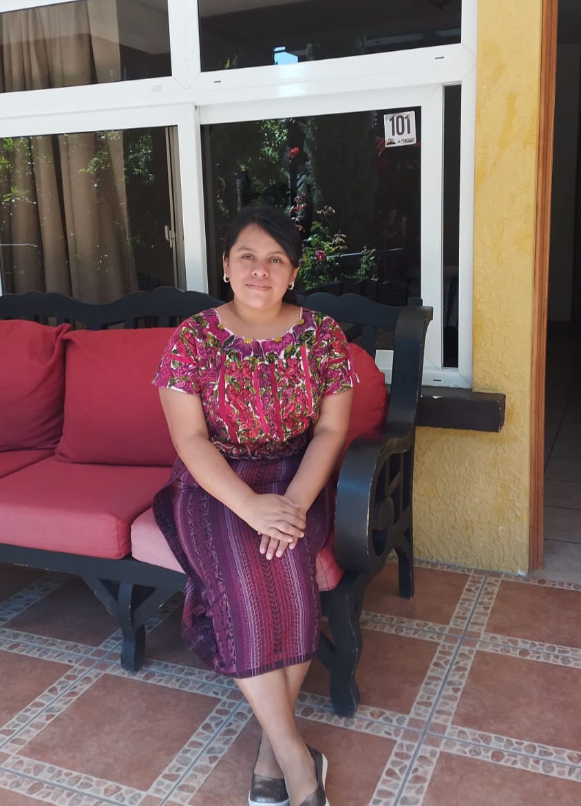 A young woman sits on a patio