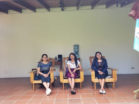 Three young women sitting in chairs