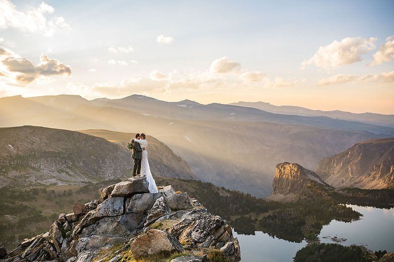 Romantic mountain wedding portraits with bride and groom overlooking Montana landscape