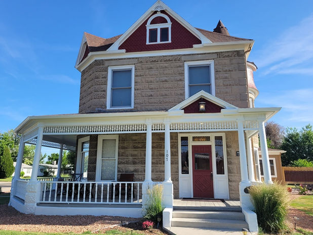Professional painting of red siding and white exterior trim in Fruita by Prime Painting Experts