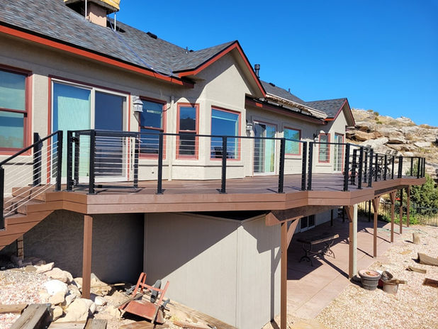 Full exterior house painting and multi-level deck staining in Grand Junction by Prime Painting Experts.