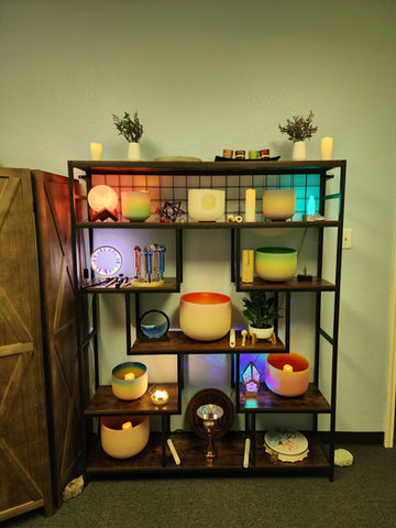 Colorful singing bowls and crystals on shelves