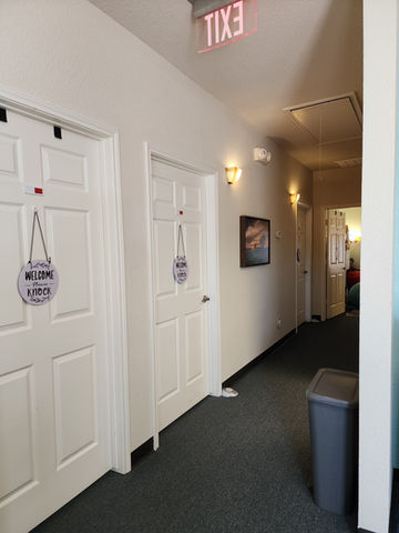 Hallway with doors and "Welcome" signs