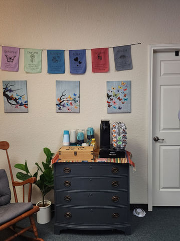 Waiting area with rocking chair, coffee station, and calming decor