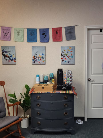 Waiting area with rocking chair, coffee station, and calming decor