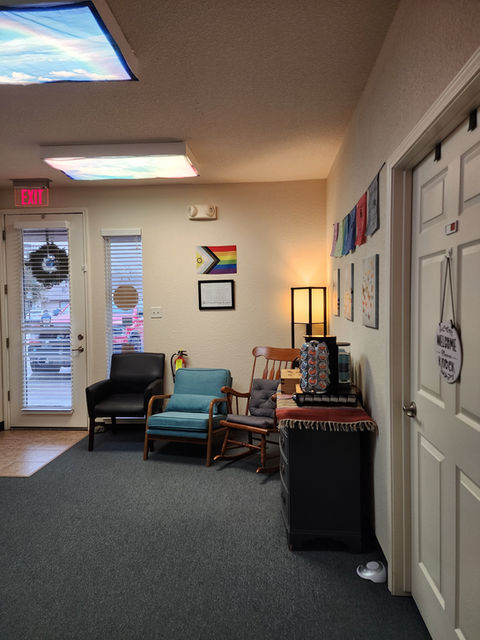 HopefulWatersWellness waiting area: comfortable seating, flags, and calming decor