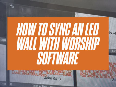 Church tech booth sending lyrics and a camera feed to an LED video wall behind the platform.
